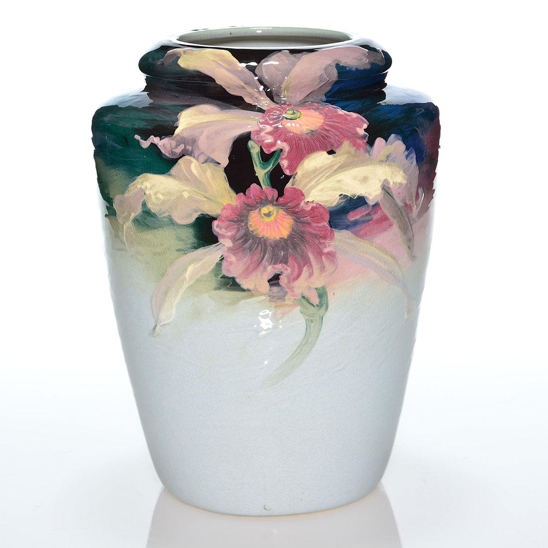 Large Weller Late Eocean vase, orchids, 11”: Sizable Weller Late Eocean vase with twin orchids in raspberry pink and lilac on the front and a shadow blossom on the back. Measures 11 inches tall and 9 inches across the shoulder. There is a small 