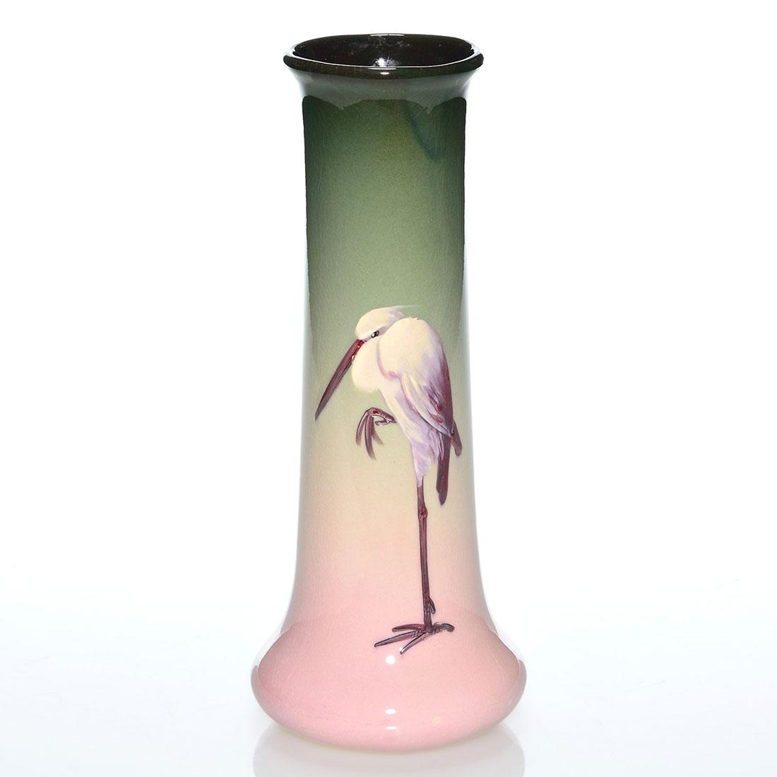 Weller Eocean vase, stork, Chilcote, 10 1/2”: Weller Eocean vase decorated with a stork painted by Charles Chilcote who signed in white slip near the base. Incised Eocean Weller and S on the bottom. There is fine overall crazing. Height is 10 1/2