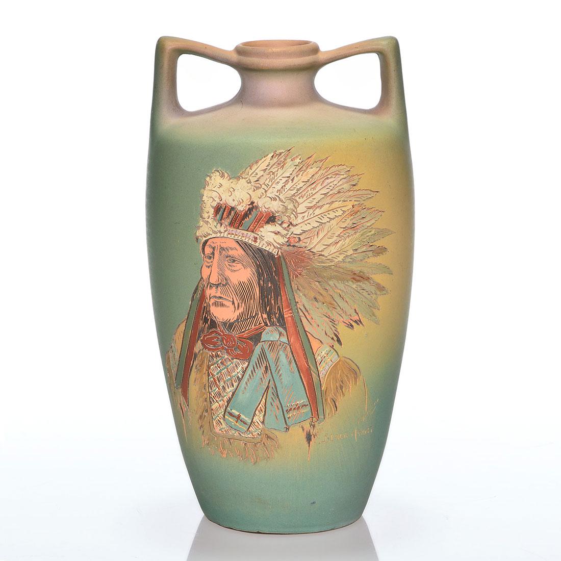 Weller Dickens Ware,Black Heart, Daugherty, 10 1/4: Weller Dickens Ware twin handled vase featuring a portrait of Black Heart done by Anna Daugherty. Signed and titled on the side by the artist. Impressed Dickens Ware Weller, X 229 and 7 on the bottom.