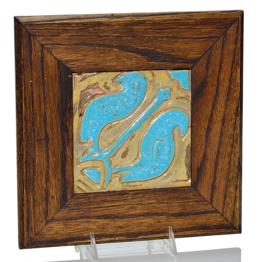 Pewabic tile, 2 birds, gold, turquoise, 5 3/4”: Pewabic 5 3/4 inch square tile carved with two birds on a branch glazed in turquoise against a gold lustre backdrop. Unmarked. Mounted in a 10 1/2 inch Arts & Crafts frame. Excellent condition.