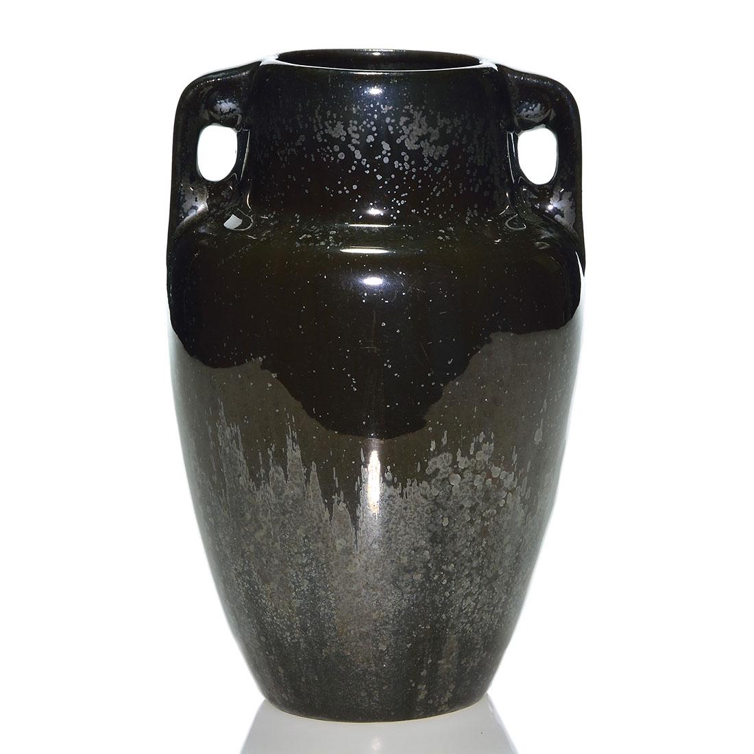Fulper vase, Mirror Black glaze, crystals, 8 3/4”: Fulper twin handled vase, shape 659, covered in the Mirror Black glaze with lots of small silver crystals. Marked with the small Fulper vertical racetrack ink stamp. There is a 1 inch firing separatio