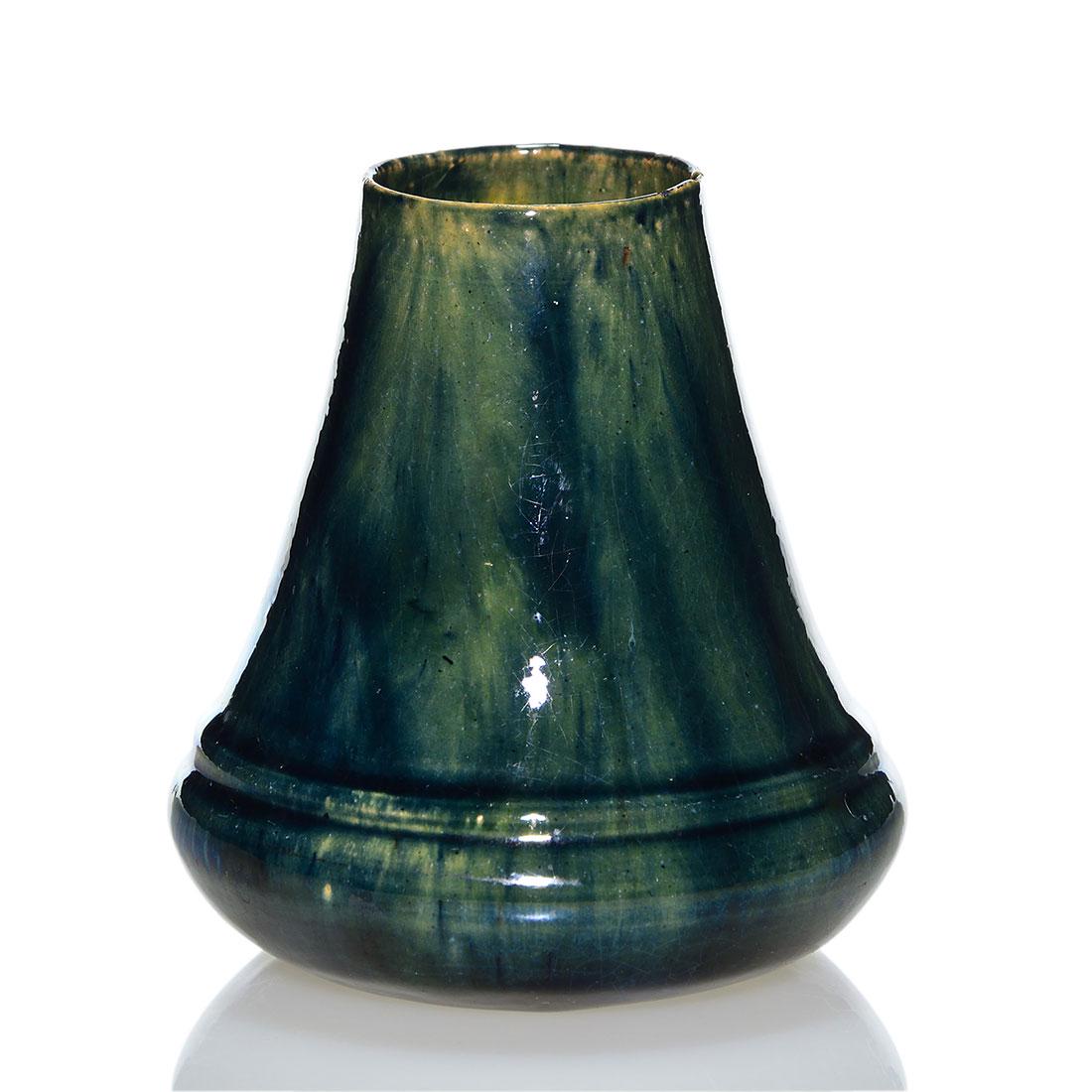 George Ohr tapering thrown vase, luster glaze,3 7/8: George Ohr hand thrown tapering vase done with a slight luster glaze. Impressed G.E. OHR BILOXI. on the bottom. Height 3 7/8 inches. Faint crazing and a tiny glaze nick off the top edge of the rim whi