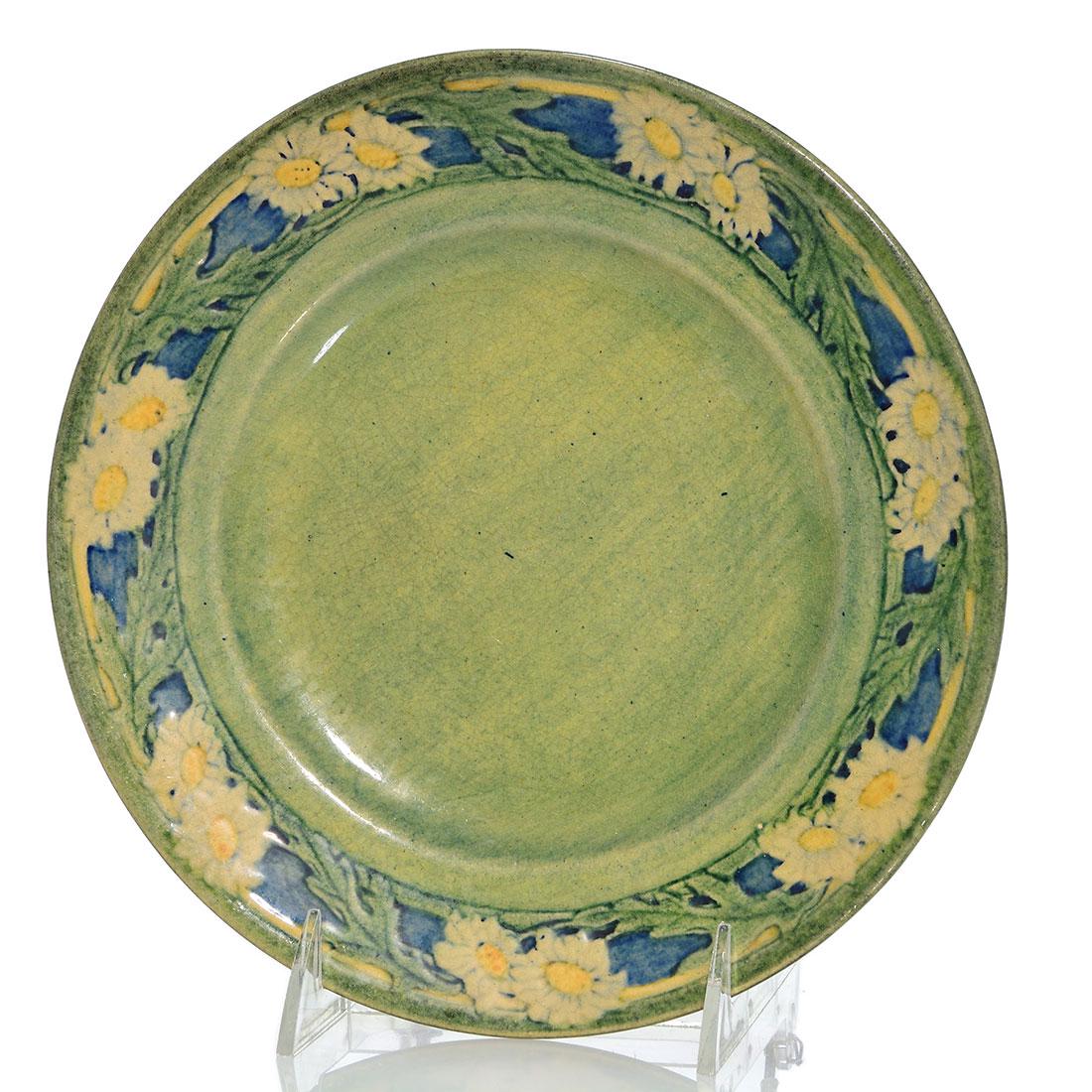 Newcomb glossy charger, daisies, Simpson, 1910, 8 1/2: Newcomb College high glaze charger with carved and painted daisy decoration done by Anna Frances Simpson in 1910. Marks include the Newcomb logo, JM for pottery Joseph Meyer, date code (DQ46) for 1910
