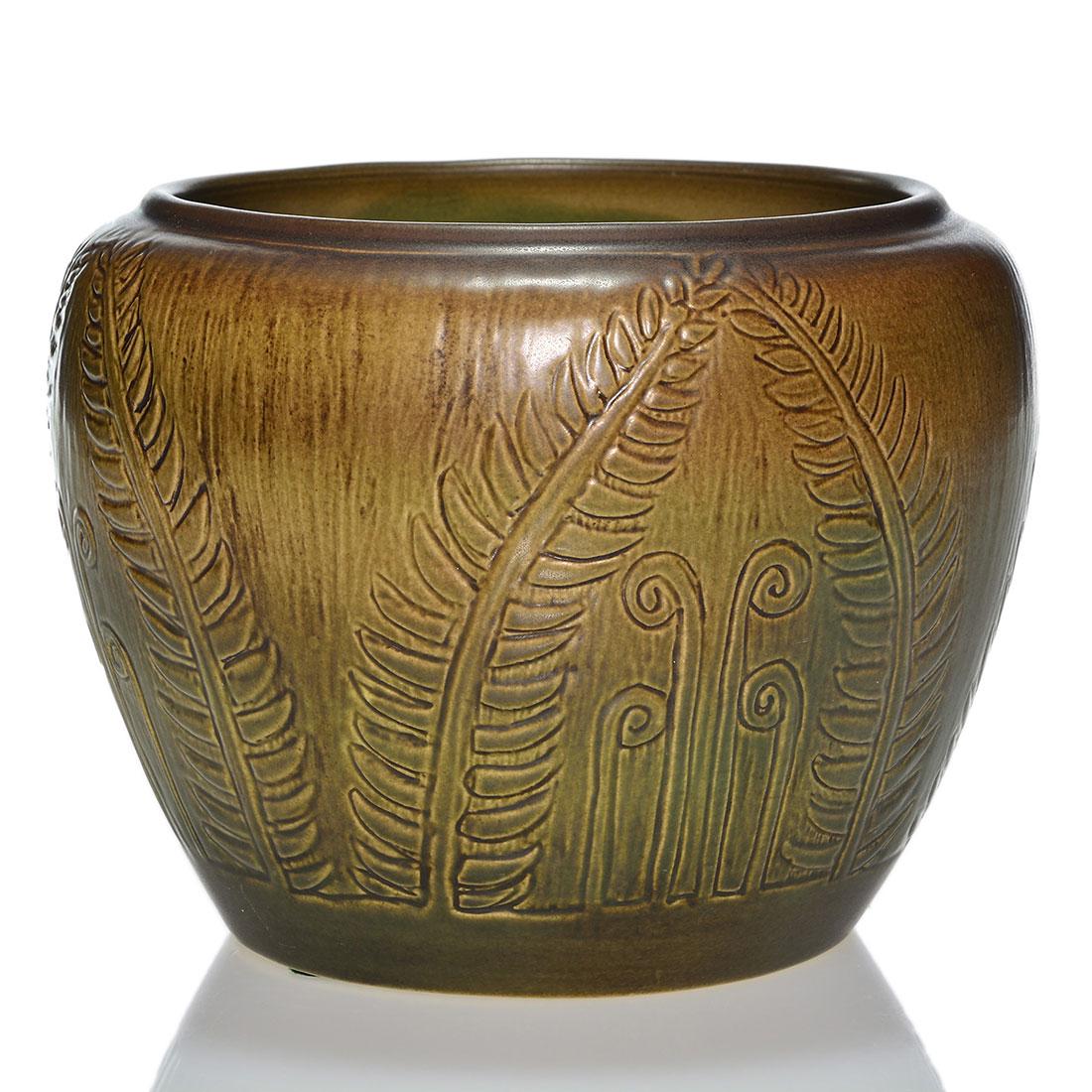 UND vase, carved ferns, Arnold & Huckfield, 5 3/4”: UND vase with incised fiddle head ferns covered in avocado green and brown glazes. Done by an artist whose last name is Arnold, most likely from a Flora Huckfield design. Measures 5 3/4 inches by 8 in