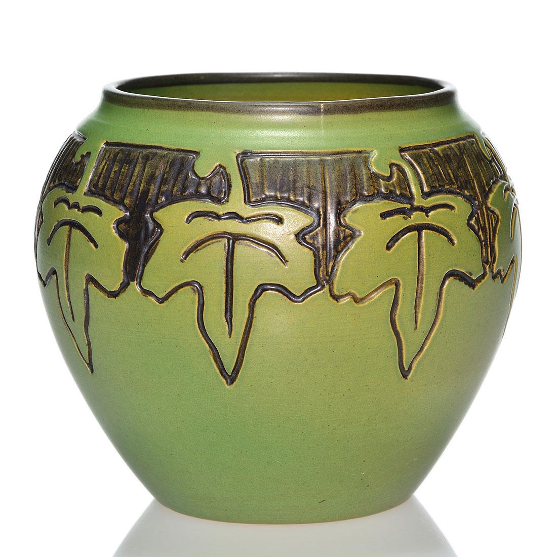 UND bowl, ivy decoration, Jensen, 5 1/2”: UND 5 1/2 inch vase with a decoration of ivy leaves, incised and outlined in black, against a black and green ground, the work of an artist named Jensen in 1943. Bearing the blue UND seal and incised