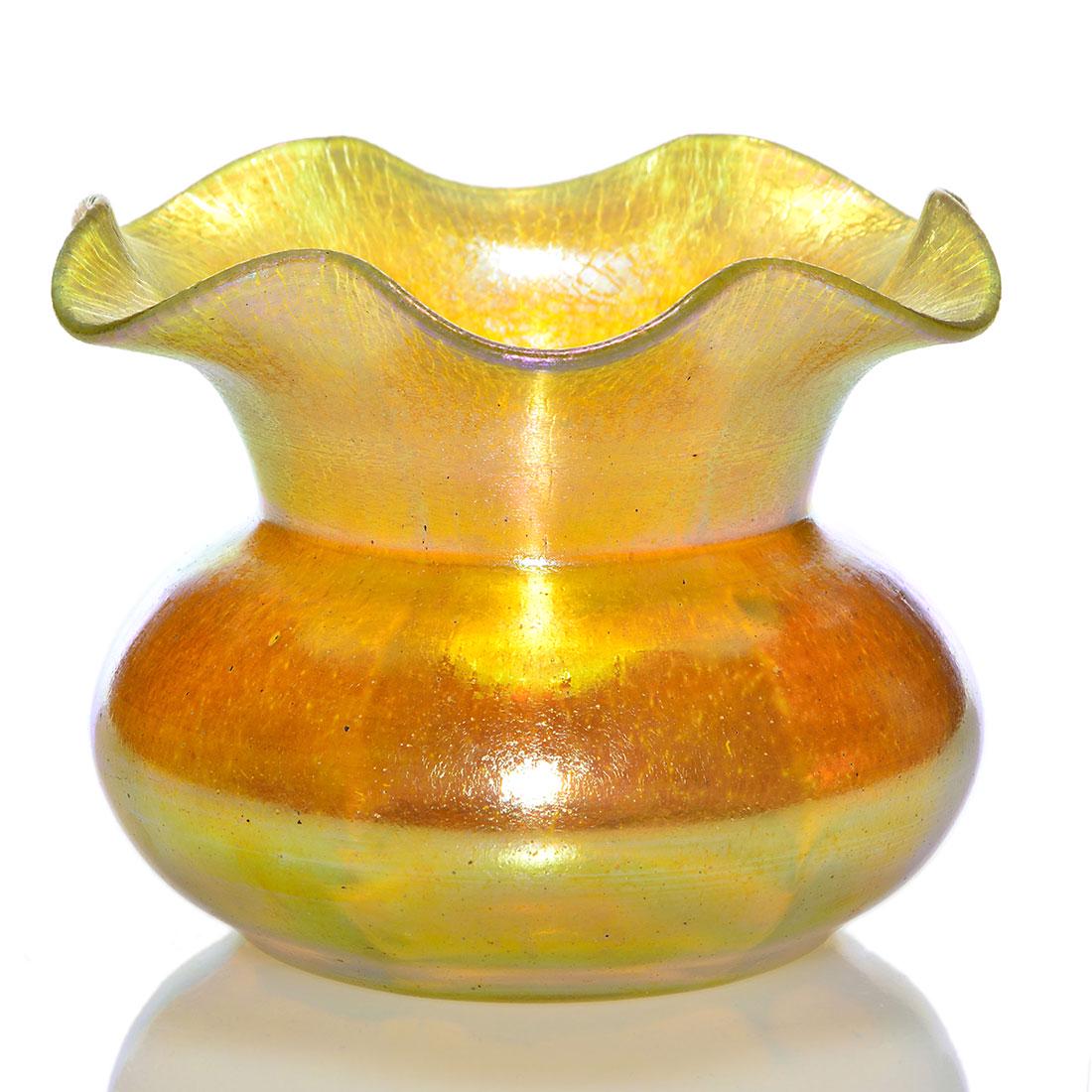 Loetz Silberiris II ruffled vase, reflective gold,5: Loetz Silberiris II vase with wide ribs and a flaring ruffled rim enhanced by stretch patterns. Measures 5 inches by 6 1/2 inches wide. Highly reflective exterior. Rainbow highlights throughout. Excel