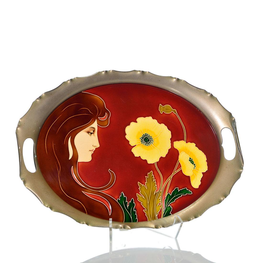 Von Schwarz tray, Karl Luber, Woman, irises 10x13 3/4: Johann Von Schwarz Norica tray, a ceramic tile housed in a metal surround with handle cutouts. The tile itself features a beautiful Art Nouveau woman with red hair looking at bright yellow poppies on 