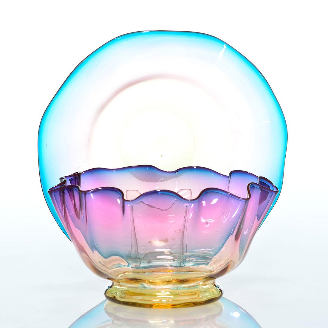 Thos Webb Alexandrite finger bowl, 2 3/4”X5”: Thomas Webb & Sons Alexandrite footed finger bowl with flaring ribbed sides. Measures 2 3/4 inches by 5 inches across. Accompanied by a ruffled underplate 5 5/8 inches across, a tiny cinder in the gla