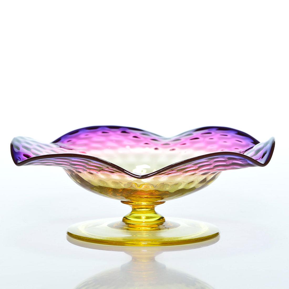 Thomas Webb Alexandrite compote, honeycomb, 5 1/2”: Thomas Webb & Sons Alexandrite flowerform compote with beautiful blue to elderberry purple color highlighting the optic honeycomb pattern. Measures 2 inches by 5 1/2 inches across. Refreshing color. E
