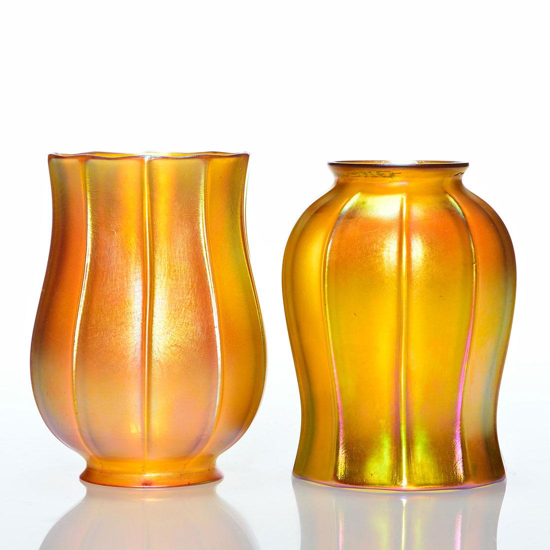 Pr. Quezal Tulip shades, gold, ribbed, 5”,: Pair Quezal tulip form shades in iridescent gold with 5 inch ribbed bodies. Each 2 1/4 inch fitter is engraved with the Quezal signature. One shade has a teensy nick on the fitter and one rib. Irregul