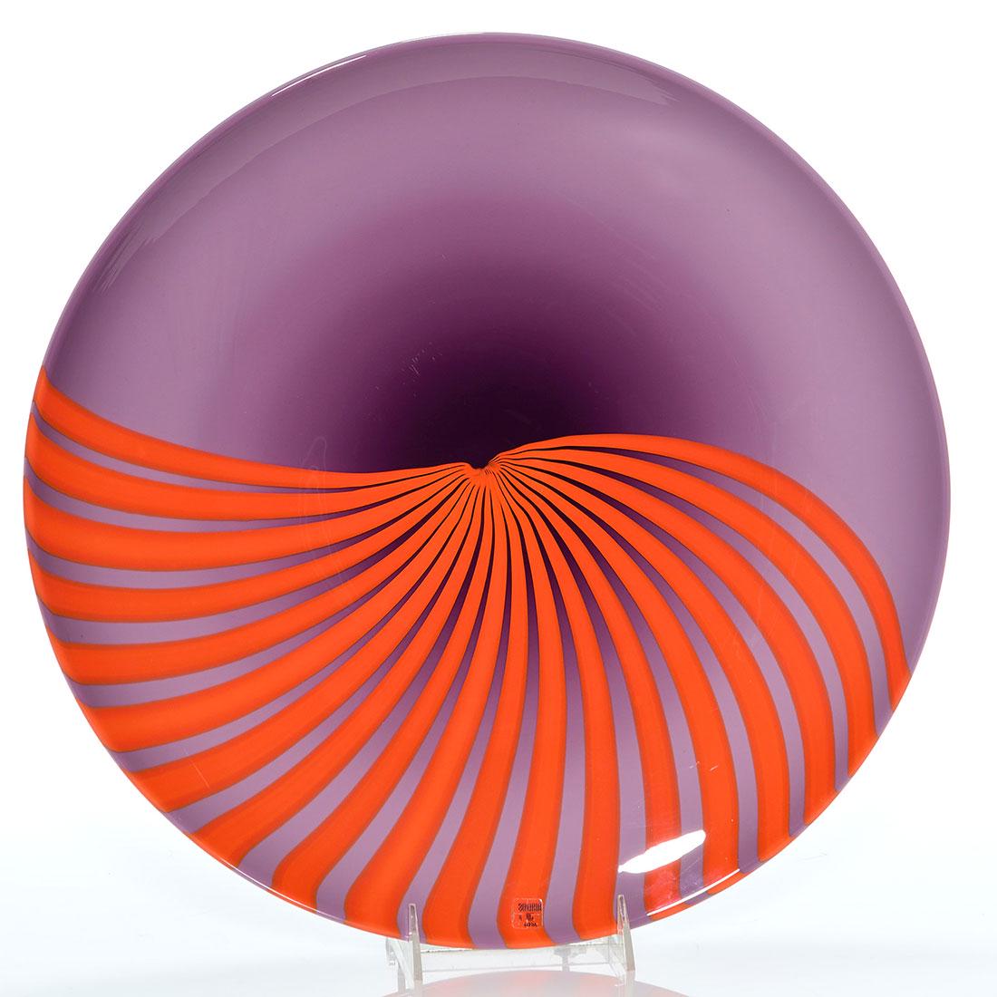 Large Vetri Murano charger, 16” D, orange rays,: Large Vetri Murano charger measuring 16 inches in diameter revealing orange rays over purple, a design by Venetian glass artist, Lino Tagliapietra. Front sticker reads Vetri VM Murano, 023. Excellent 