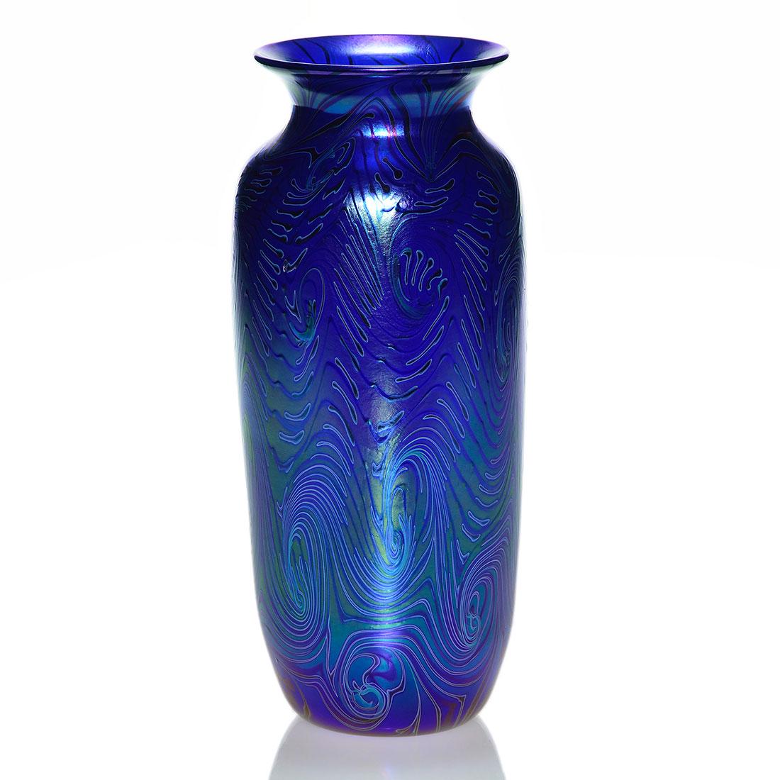 Early Orient & Flume vase, blue King Tut, 10 1/2”: Early Orient & Flume cobalt blue vase with an interesting feathery outline of the King Tut design combined with the zipper pattern created in 1981. Height is 10 1/2 inches. Engraved Orient & Flume, 81