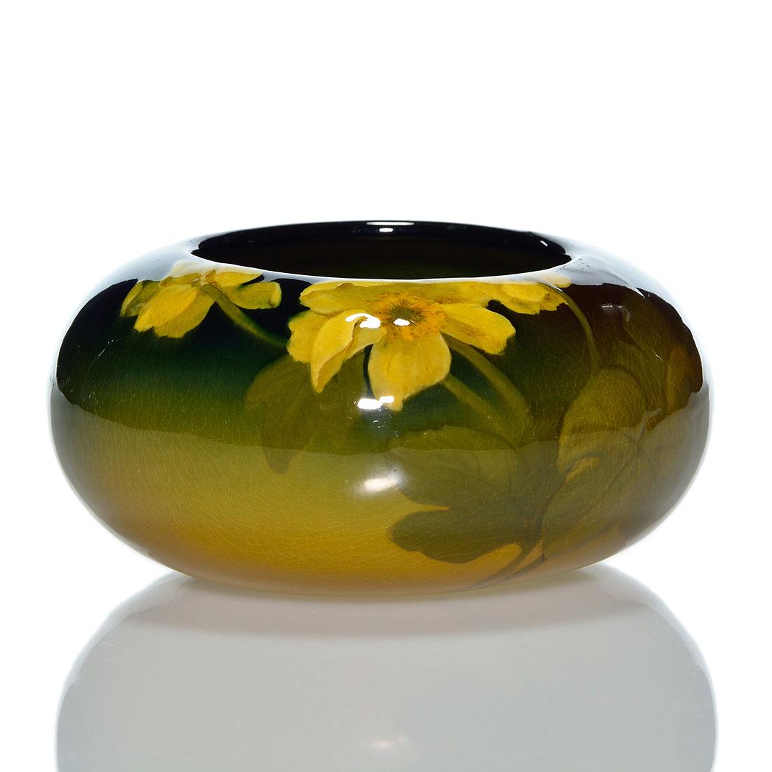 Rookwood Standard vase, floral, 6 1/2”D,: Standard glaze round vase with marsh marigold decoration by Laura Lindeman in 1905. Measures 3 inches by 6 1/2 inches across. Marked with the factory symbol, date, shape 24B and the incised cypher of 