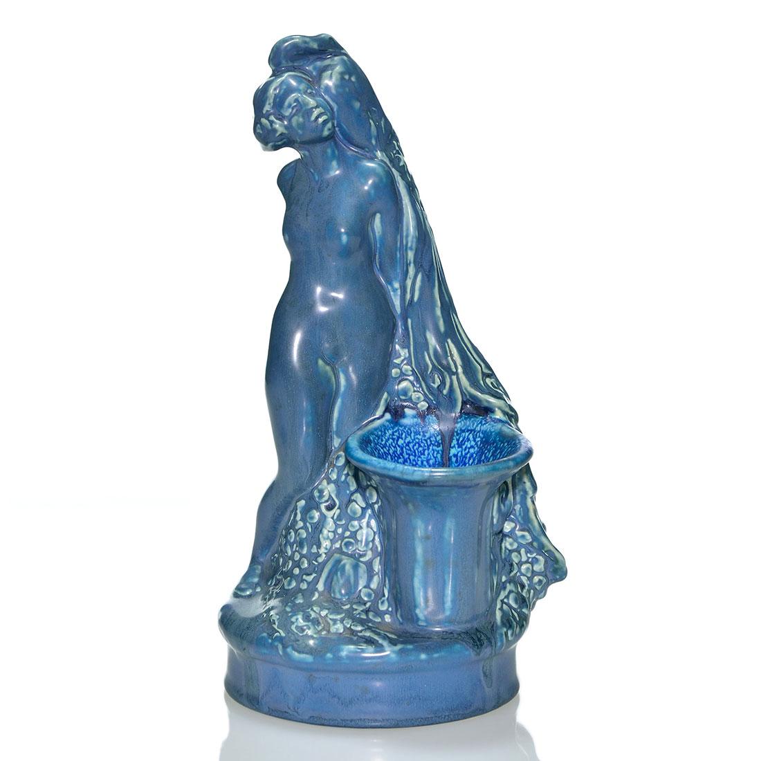 Rookwood “lady with Peacock” mat: Rare figural of a nude woman with a peacock flower holder, cast in 1920 and covered with a dark over medium blue mat glazes. Marks include the Rookwood logo, date and shape 2270. Excellent original co