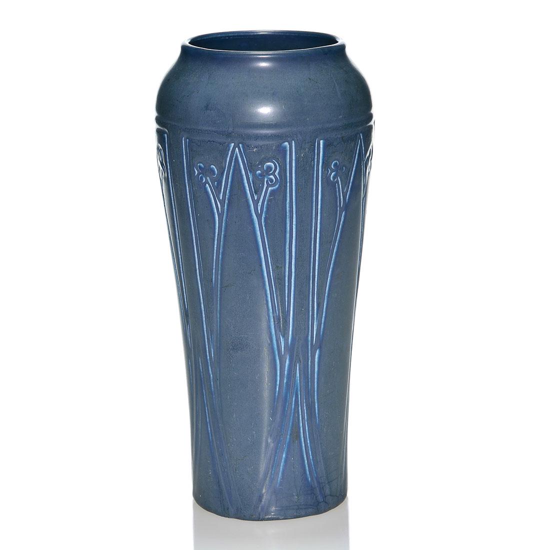 Rookwood production vase, floral, 1920, 2335, 11 1/4: Production vase with molded floral design cast in 1920 and covered with dark over light blue mat glazes. Marks include the Rookwood logo, date and shape 2335. There is fine overall crazing. Height is