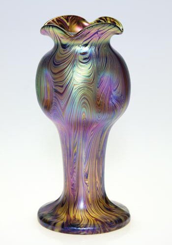 Loetz vase, thumbprint, combed design, 9": Loetz vase resembling a budding flower, the surface combed with a pleasing overall pattern. The vase is highly reflective with amethyst, green, gold and pink. Four thumbprints are impressed on the swo