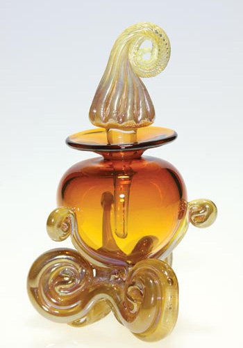 Chuck Sorrels perfume, stopper, 6": Chuck Sorrels perfumer with stopper, the honey amber urn body lofted upon a golden scrolled base. Nice scrolled stopper has long dauber. Combined height 6 inches. Engraved "Mango" on the side of the b