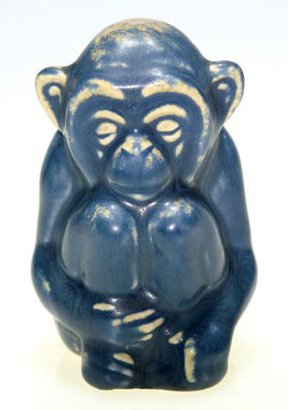 Rookwood 3 3/4" seated monkey, #6084, tan & blue m: Paperweight depicting a contemplative monkey, a Shiri design, cast in 1929 and covered with the blue and tan mat glaze. Impressed with the Rookwood insignia, the date and shape 6084. No crazing. Heigh