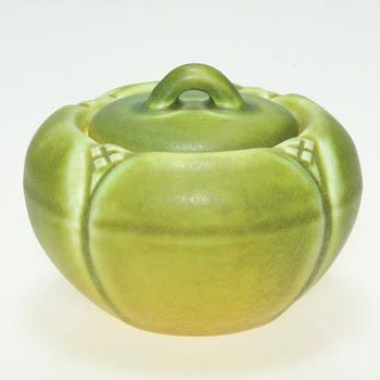 Rookwood lidded box, green mat, 1910, 1684,: Production lidded box, 2 1/2 inches tall, cast in 1910 and covered with a mat green glaze with ochre accents. Impressed with the Rookwood logo, the date, shape 1634 and a V. There is fine overall craz