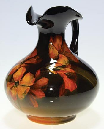 Rookwood Standard 7 3/4" ewer, floral, Baker: Standard Glaze ewer decorated in 1899 by Constance Baker, who painted a bright spray of gladiolas. Impressed with the Rookwood logo, which provides the date, and shape 718 and incised with the artist 