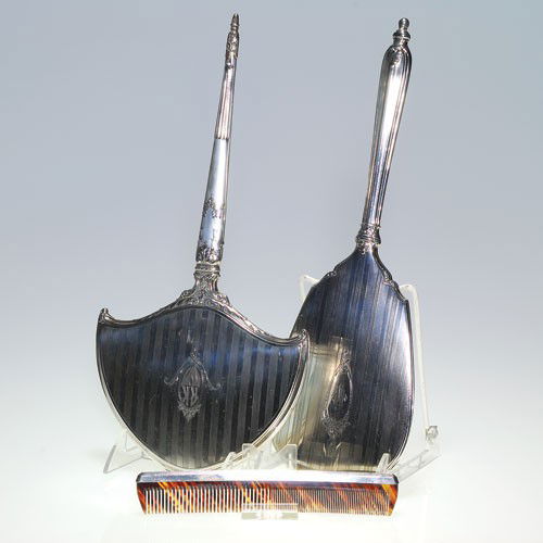2 Art Deco Sterling vanity hand mirrors & tortoise shel: Two Art Deco Sterling silver hand mirrors with a similar design and repousse pattern. Lengths are 14 inches and 13 1/2 inches, marked "Sterling", one mirror impressed with "Alvin" logo. A tortoise she