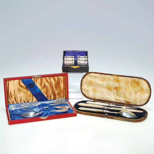 Silver lot:Pr napkin rings; Juvenile set; MOP handled f: Three lots of silver in presentation cases: 1)Pair of English napkin rings by Thomas Bradbury & Sons, 1 1/4 inches by 1 3/4 inches. Impressed with a crown, a lion, capital Old English D and the makers