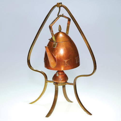 WMF German Secessionist Copper & Brass teapot & stand,1: WMF German Secessionist tea kettle suspended from a spade form stand with warmer, crafted from copper and brass. The kettle has a hinged lid, the handle wrapped and braided with natural cane. The kett
