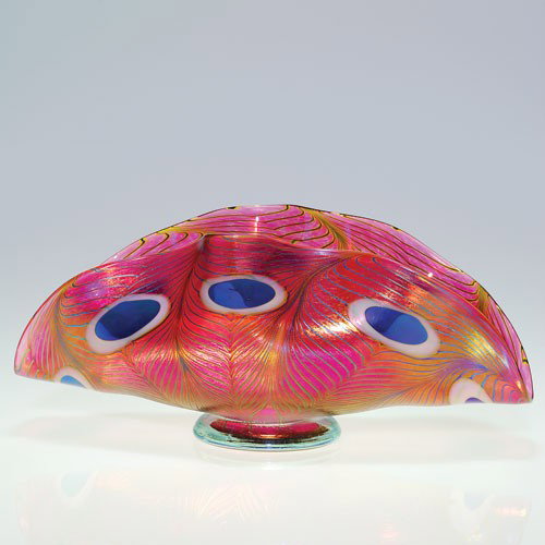 Robert Held "Peacock feather" fruit compote, rose, blue: Fan shape fruit compote made by Robert Held encompassing eight peacock feathers about the perimeter Height 5 1/4 inches, the width 12 inches. Signed "R. Held Art Glass" below the pale blue base. Very 