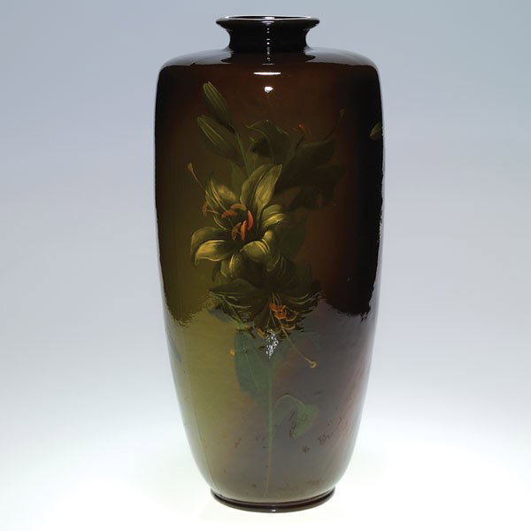 Weller Louwelsa 18 1/2" vase, Lillie Mitchell.: Weller Louwelsa vase decorated with large lilies by Lillie Mitchell. Impressed with the Weller Louwelsa logo, K, X 206 6 and signed "L. Mitchell" on the side. There is crazing, a few small glaze bubbl