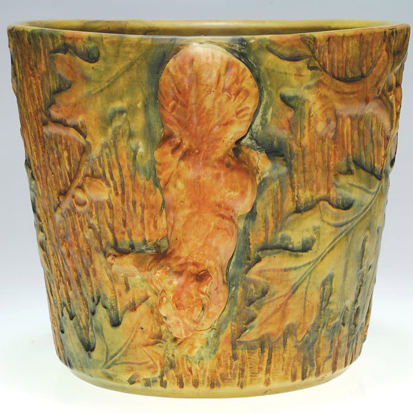 Weller Woodcraft 9 1/4" X 11 1/2" jard, squirrel.: Weller Woodcraft jardiniere encircled with an oak tree, a squirrel climbing down one side. Impressed on the base Weller in block letters. There is fine crazing and a second squirrel, on the opposite s