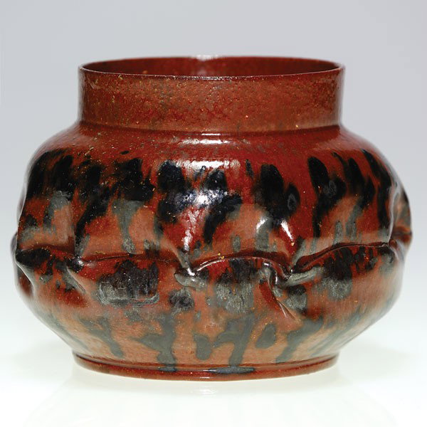 George Ohr vase, some twisting, decoration: Good George Ohr vase with some decoration and a lot of twisted clay. Black streaks and drips accompany an area of deformed clay in the middle of the body. Impressed "G.E. Ohr Biloxi, Miss." on the bot