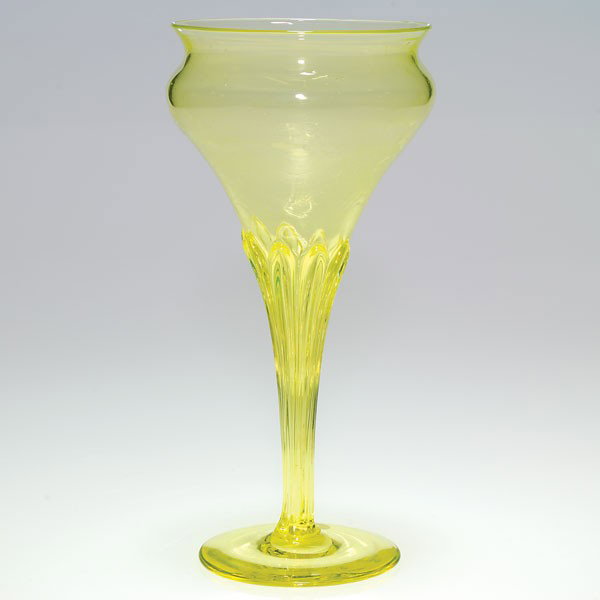 Tiffany chalice vase, citron yellow, 9", signed: Good Tiffany floral form chalice vase in a pretty citron yellow. The stem is molded with a sheath of leaf blades caressing a shapely bowl. Encircling the interior of the bowl is a whispy cloud-like pa