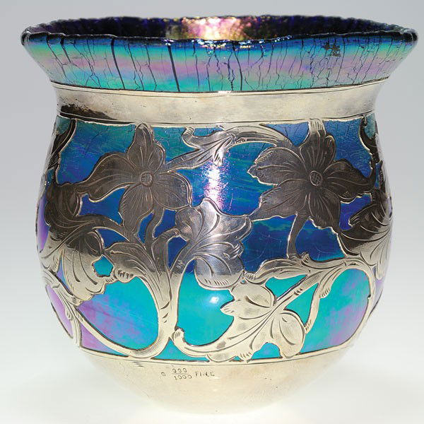 Austrian (Loetz?) blue vase with silver overlay, 5: Austrian (Loetz?) vase in iridescent blue with a flowering vine in silver overlay. Height 5 3/8 inches, diameter 5 1/2 inches. The silver is marked "S 999/1000 Fine." The glass is heavy and thick. The