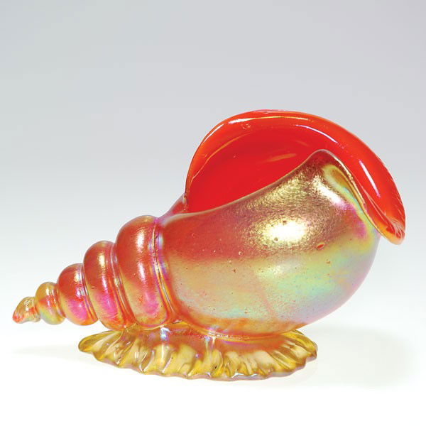 Loetz conch shell, two color orange & gold, 4 1/4": Good Loetz conch shell lifted on an iridescent gold base resembling a placid wave, looking as tho it has just washed onto shore. The shell is vibrant in color revealing an orange interior encased with