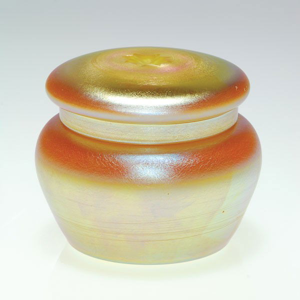 Durand covered dresser box, intaglio rosette on li: Durand dresser box and cover in iridescent gold over calcite. The cover has an eight point star intaglio carved in the very center. Height 2 3/4 inches. Beautiful excellent condition.