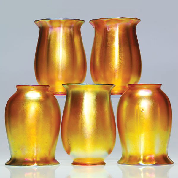 5 Quezal gas shades, gold, ribbed, signed, 5": Five Quezal tulip shades, iridescent gold with ribbed bodies. Height 5 inches. The company name is engraved on each of the 2 1/4 inch fitters. Pretty magenta iridescence. The set is in excellent condi