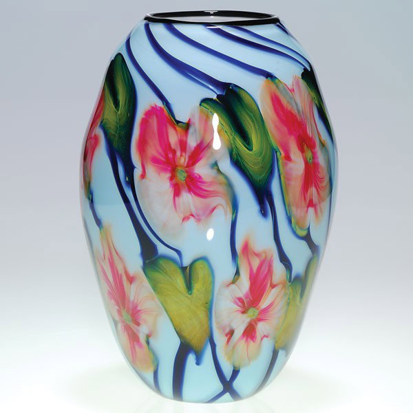 Charles Lotton Multi Flora vase, 9 3/4", artist si: Good Charles Lotton Multi Flora vase with ten morning glory flower heads in cranberry attractively amassed over a nice lavender white backdrop. The flowers cling to cascading cobalt blue stems accompa