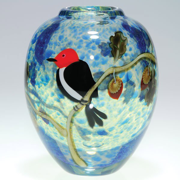 Orient & Flume woodpecker, 5 3/4", "Alexander": Orient & Flume paperweight vase showing a red headed woodpecker leisurely perched on an oak tree branch with acorns, a mottled sky of blue behind created by Ed Alexander Height 5 3/4 inches. Engraved 