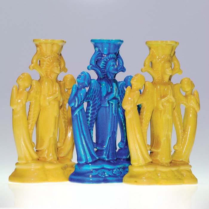 Three Cowan "Angel" 8 7/8" candleholders: Cowan pair of "Byzantine" angel candlesticks, shape 746, covered with a light brown gloss glaze and one in dark blue gloss. Impressed with the circular Cowan mark. Height 8 7/8 inches for each. There 