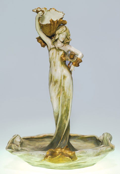 Tall Amphora RSt&K figural, women, 27 1/8" tall: Tall Riessner, Stellmacher & Kessel (Amphora) figural, a beautiful Art Nouveau woman holding a large open flower and a garland of normal size flowers. Two other beautiful women gaze upward from the un
