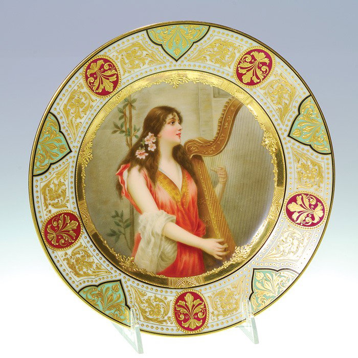 Royal Vienna plate, maiden with harp, Wagner: Royal Vienna porcelain plate, signed Wagner who painted a beautiful young maiden strumming a Celtic harp. She is clothed in a salmon color gown, her auburn hair adorned with pink wild roses. The borde