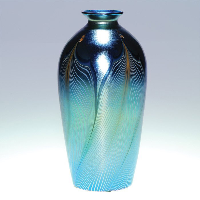 Durand attributed vase, pulled feather, 10": Good lusterware vase attributed to Durand exhibiting the combed patterns of opal feathers having curled tips edged in dark blue and placed over a nice aurene blue. Height 10 inches. Polished pontil. U