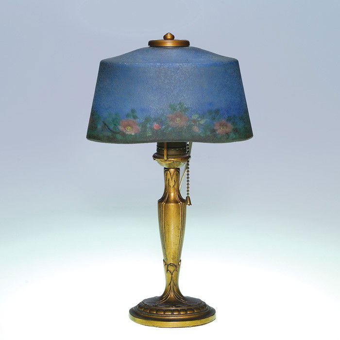 Moe Bridges attributed boudoir lamp, wild roses: Nice boudoir lamp attributed to Moe Bridges. The oval ice chipped shade is artistically reverse painted with pink wild roses strewn among the green foliage encircling the border and below a sky of blu