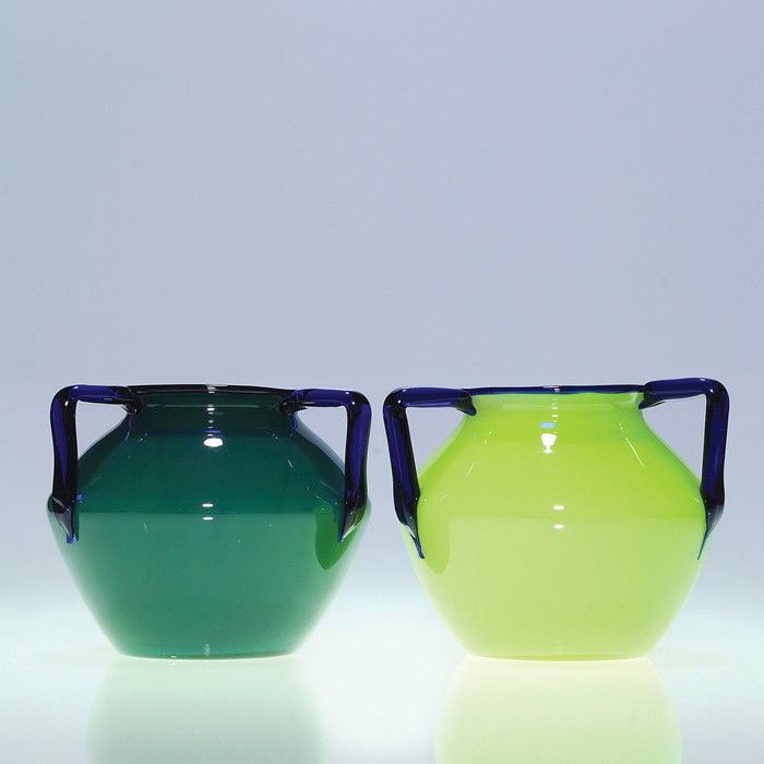 2 Czechoslovakia vases, green with blue, Loetz: Two Czechoslovakian Tango vases with an attribution to designer Michael Polowny for Loetz. One vase lime green, the other bluish green, both sporting a trio of cobalt blue handles. Heights are 5 inche