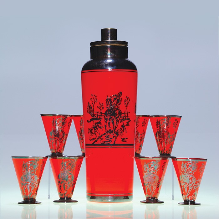 Czechoslovakia Silver overlay cocktail shaker, tumb: Good Czechoslovakian "Fox Hunt" Tango cocktail shaker accompanied by 8 footed tumblers. The set in red orange having in silver overlay hounds running along side a rider on horseback. The design repeat