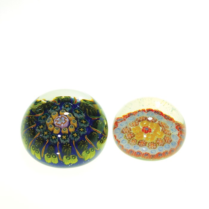 2 miniature Millefiori paperweights, 1 5/8",1 1/2": Two miniature Millefiori paperweights, possibly Baccarat. The larger measuring 1 5/8 inch by 2 1/4 inch having a sapphire blue backdrop embedded with yellow and blue canes containing flowers and cross