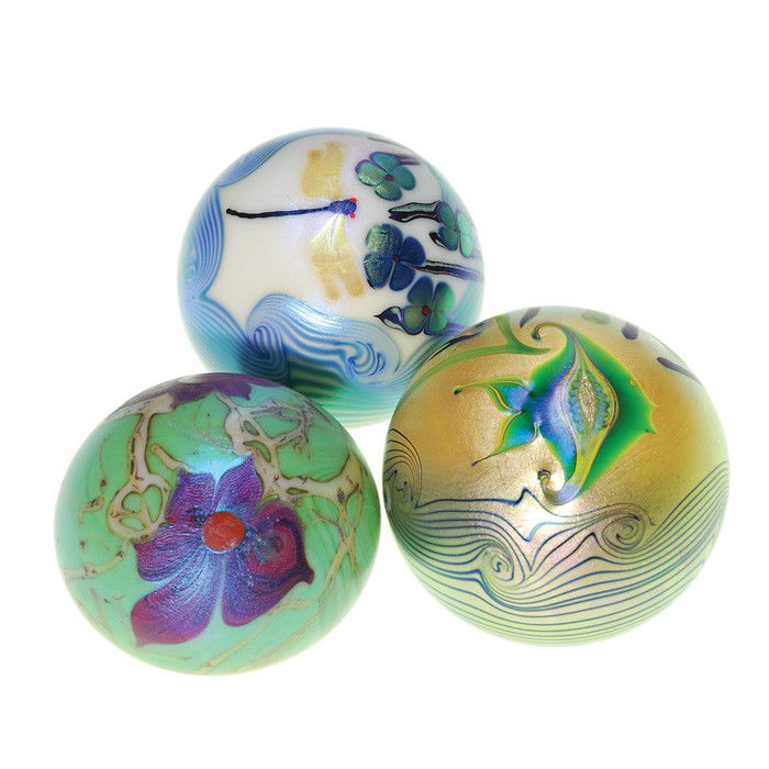 3 Orient & Flume paperweights:dragonfly, fish: Trio of Orient & Flume "Flora and Fauna" paperweights displaying either a hovering dragonfly, a swimming angel fish or two flowers on a vine. The critters are nestled in scrolling waves with blossoms.