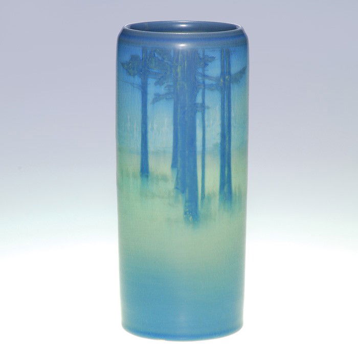 Rookwood Vellum snow scene, Coyne, 1913, 9 1/8": Vellum Glaze 9 1/8 inch scenic vase depicting a stark winter landscape with pine trees, done by Sallie Coyne in 1913. Impressed with the Rookwood symbol, the date, a V for Vellum and shape 952 D and i