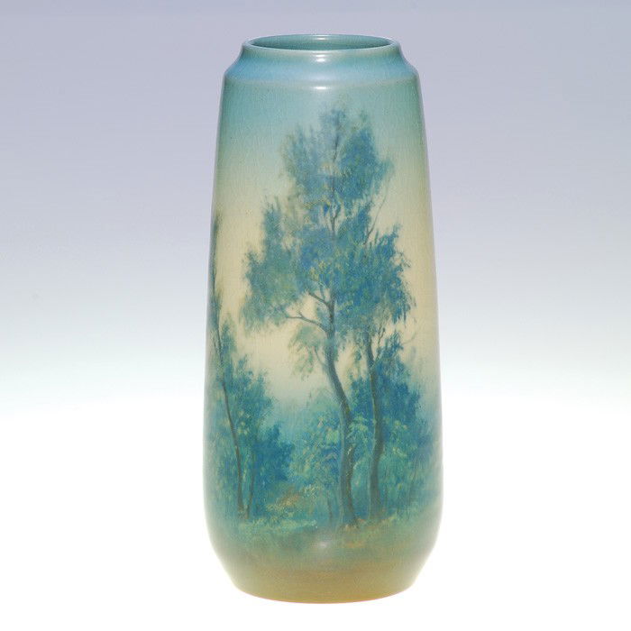 Rookwood scenic Vellum vase, Diers, 1917, 7 3/4": Scenic Vellum 7 3/4 inch vase created in 1917 by Ed Diers, who arranged leafy trees on a hill looking over a misty valley. Impressed with the Rookwood logo, the date, a V for Vellum and shape 2060 and