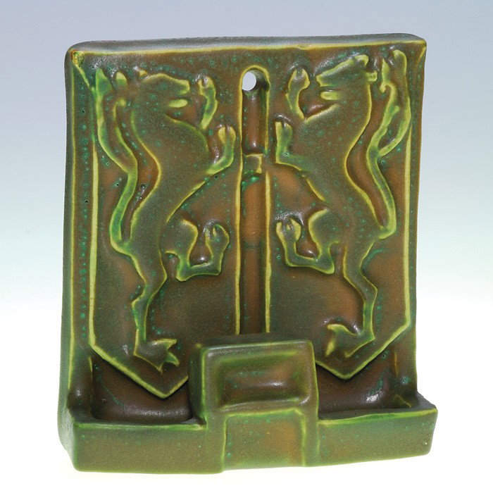 Rookwood match holder, mat glaze, rampant lions: Rookwood mottled green over rose mat glaze match and match box holder with rampant lion theme done in 1910. The original design is by Sallie Coyne whose initials are mold cast into the bottom of the p